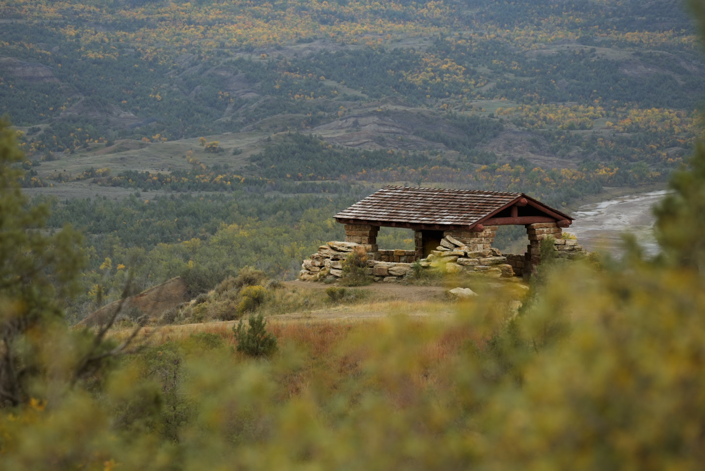 A stone overlook shelter above a river valley in the badlands